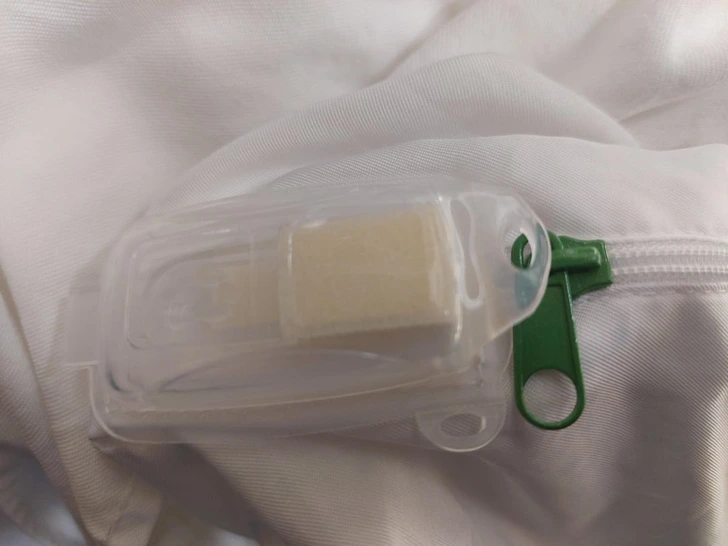 What is this white plastic clip with square foam-looking thing attached to the corner of a pillow underneath the pillowcase in my hotel room?